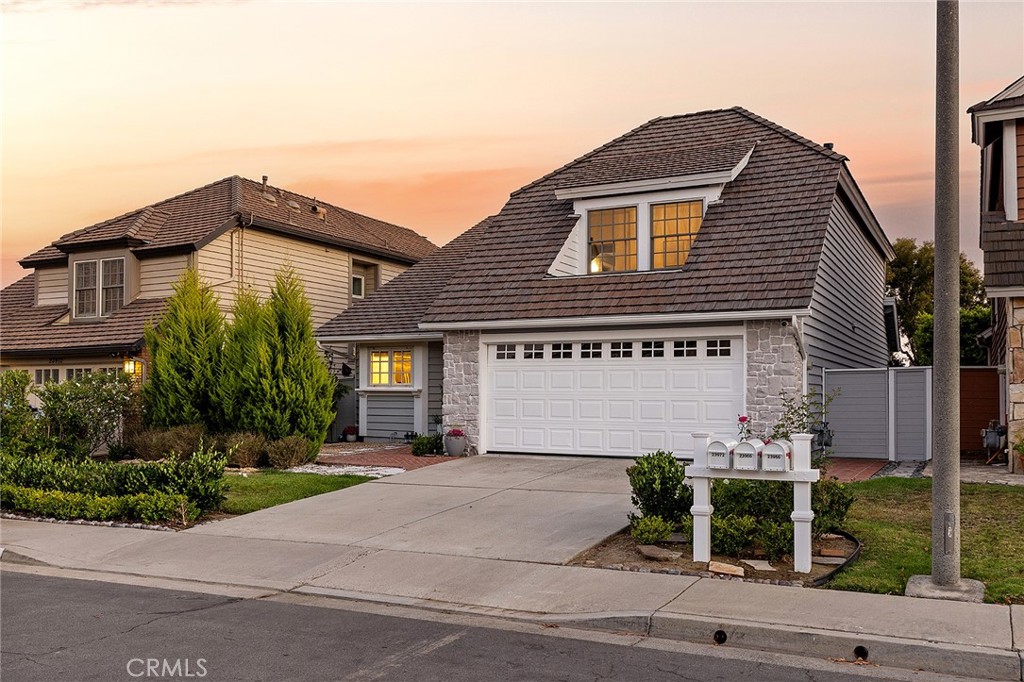 23966 Wanigan Way Laguna Niguel, CA 92677 - Photo 50 of 57 a front view of a house with a yard and garage