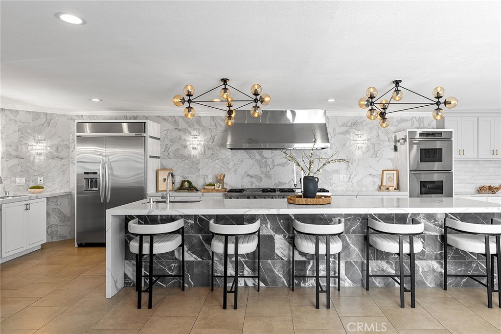 23966 Wanigan Way Laguna Niguel, CA 92677 - Photo 5 of 57 a kitchen with cabinets and chairs
