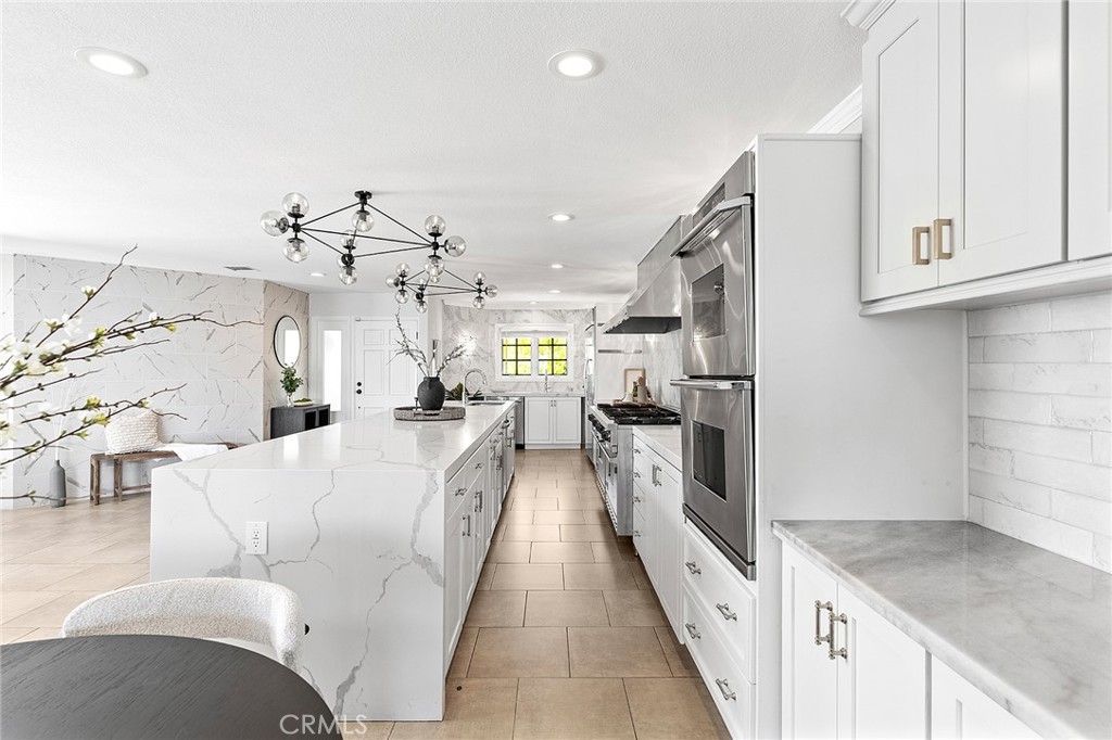 23966 Wanigan Way Laguna Niguel, CA 92677 - Photo 9 of 57 a large white kitchen with a lot of counter space