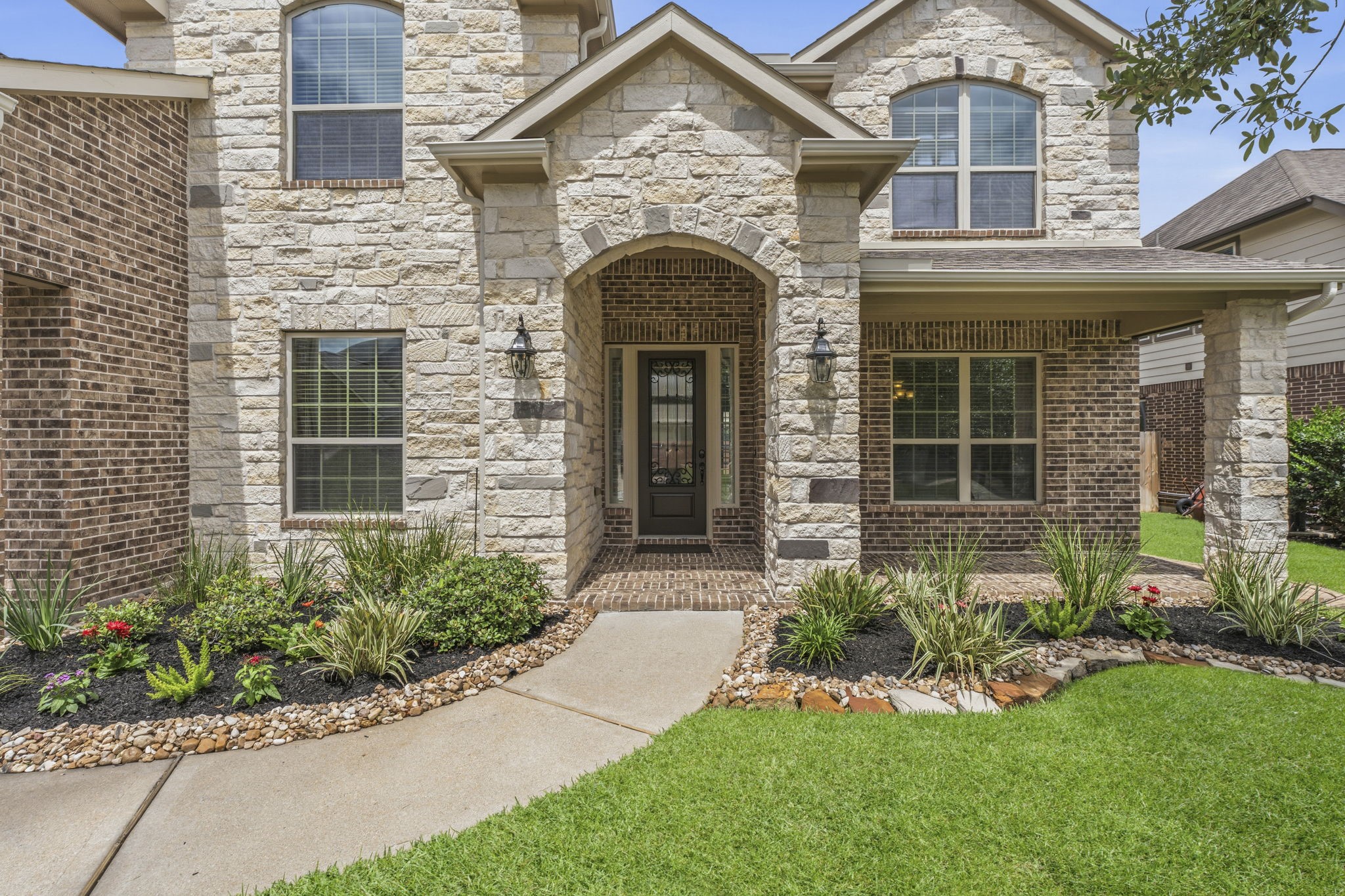 25210 Gaddis Oaks Drive Spring, TX 77389 - Photo 2 of 50 front view of a house with potted plants and a yard