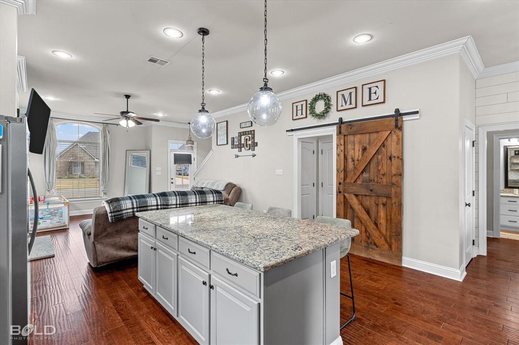 946 Maize Street Bossier City, LA 71111 - Photo 23 of 39 a kitchen with stainless steel appliances granite countertop a sink refrigerator and wooden floor