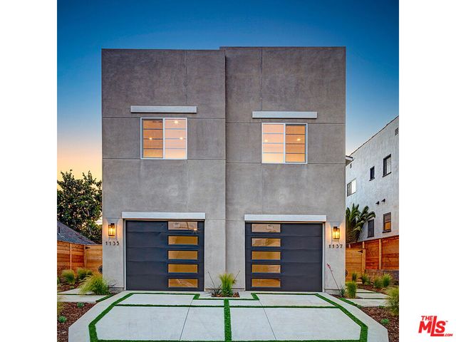 a front view of house with a garden