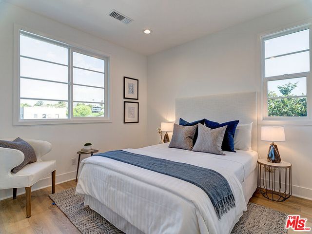 a bedroom with bed and a window