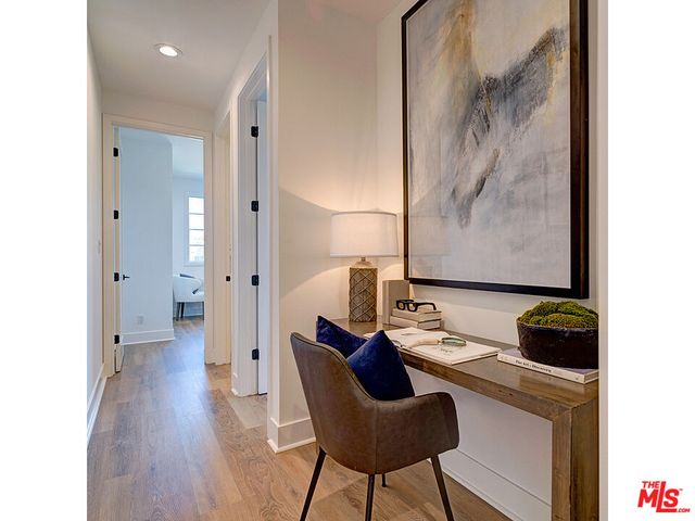 a view of a workspace with furniture and wooden floor