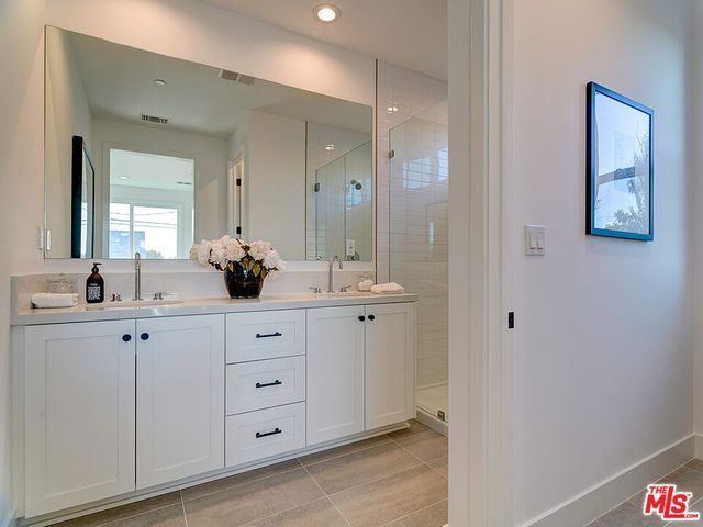 a bathroom with a double vanity sink and mirror