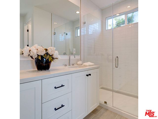 a bathroom with a sink a vanity and a mirror
