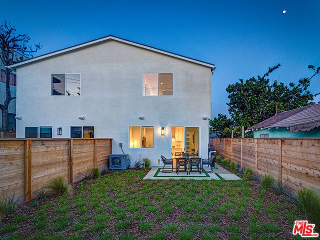 a view of a backyard with sitting area
