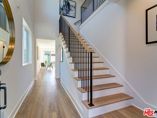 a view of entryway and hall with wooden floor