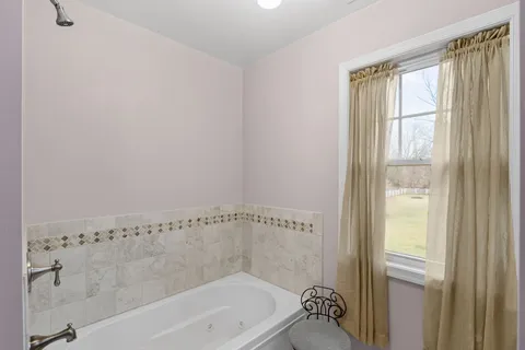 a bathroom with a bathtub and shower