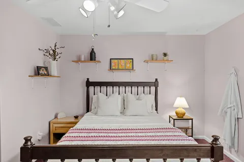 a bedroom with a bed and a lamp on table