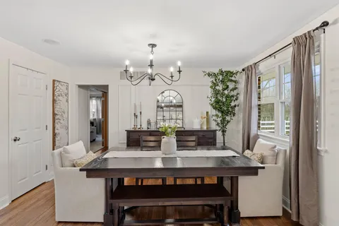 a view of a dining room with furniture and chandelier