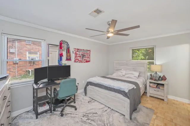a bedroom with a large bed and a ceiling fan