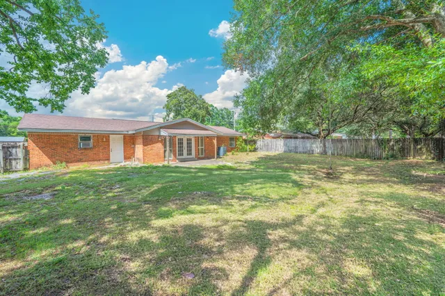 a backyard of a house with table and chairs
