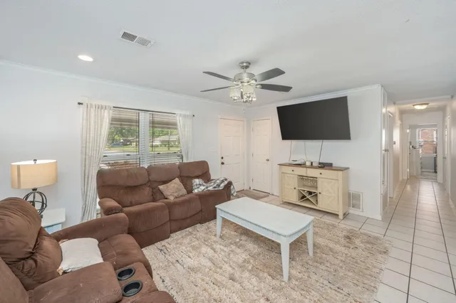 a kitchen with stainless steel appliances kitchen island granite countertop a refrigerator a stove a microwave oven with a dining table and chairs