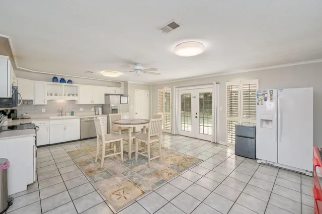 a kitchen with granite countertop a stove top oven microwave and cabinets