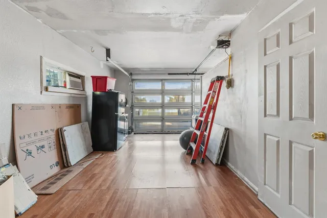 a view of entryway with furniture and wooden floor