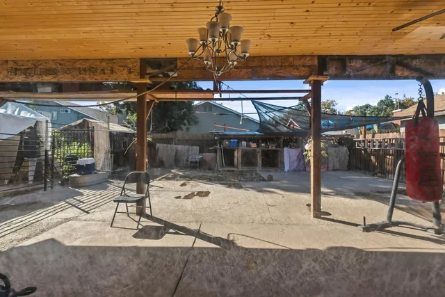 a view of a patio with a table and chairs