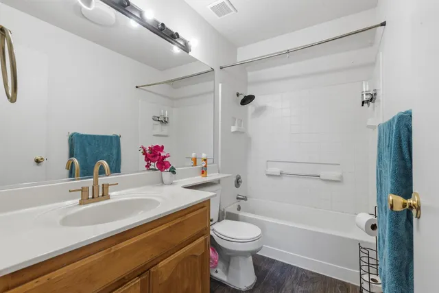 a bathroom with a sink toilet vanity and shower