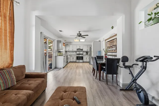 a living room with furniture and kitchen view