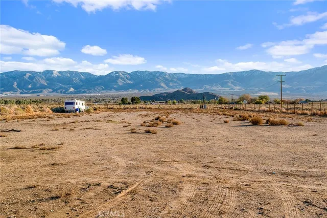 a kitchen with kitchen island wooden floor center island and stainless steel appliances