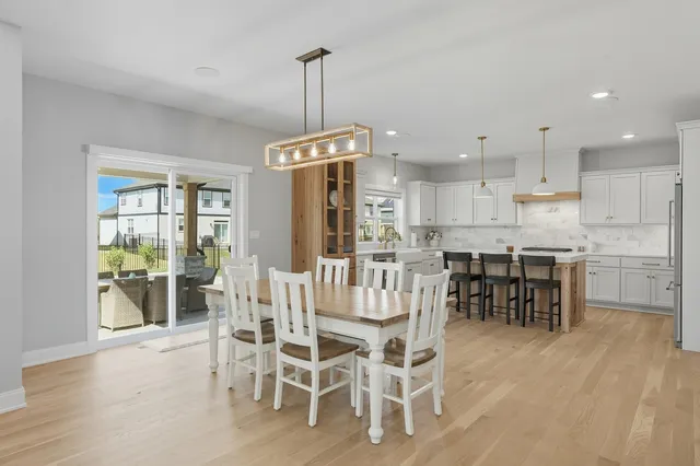 a view of kitchen with kitchen island dining table and stainless steel appliances