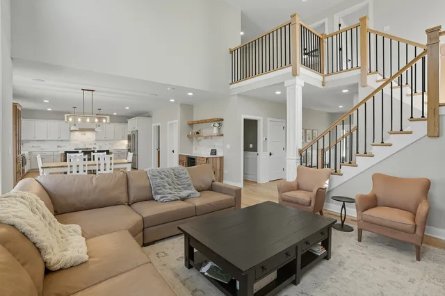 a living room with furniture kitchen view and a dining table