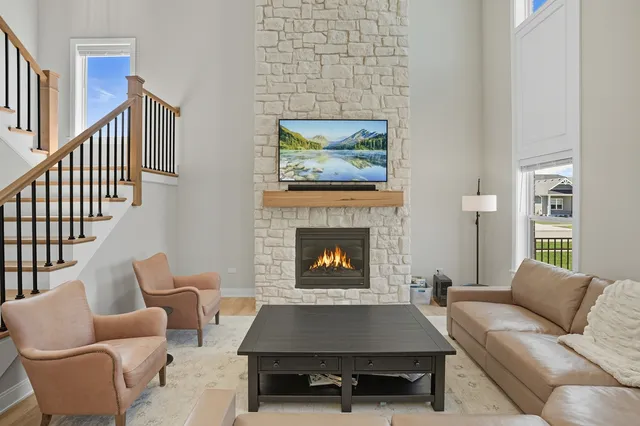 a living room with furniture and a fireplace