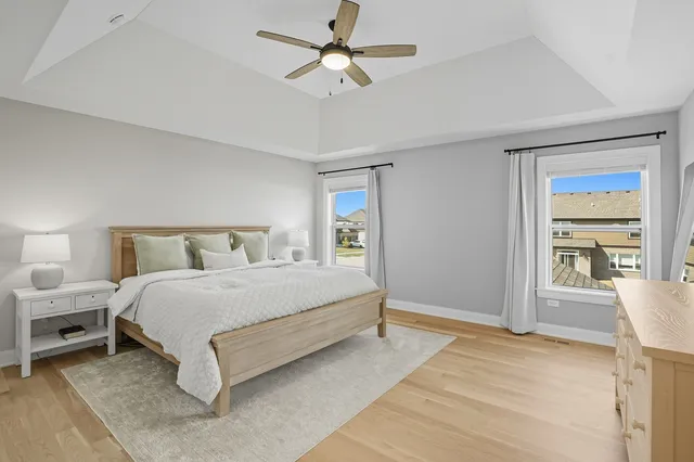 a spacious bedroom with a bed and a large window