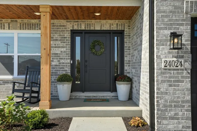 a view of a brick house with potted plants