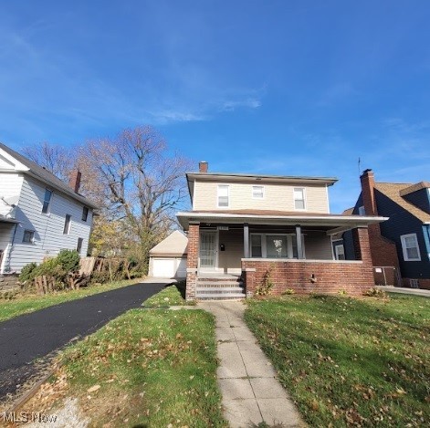 18225 Landseer Road Cleveland, OH 44119 - Photo 1 of 12 View of front facade with covered porch, a chimney, brick siding, a front lawn, and a garage