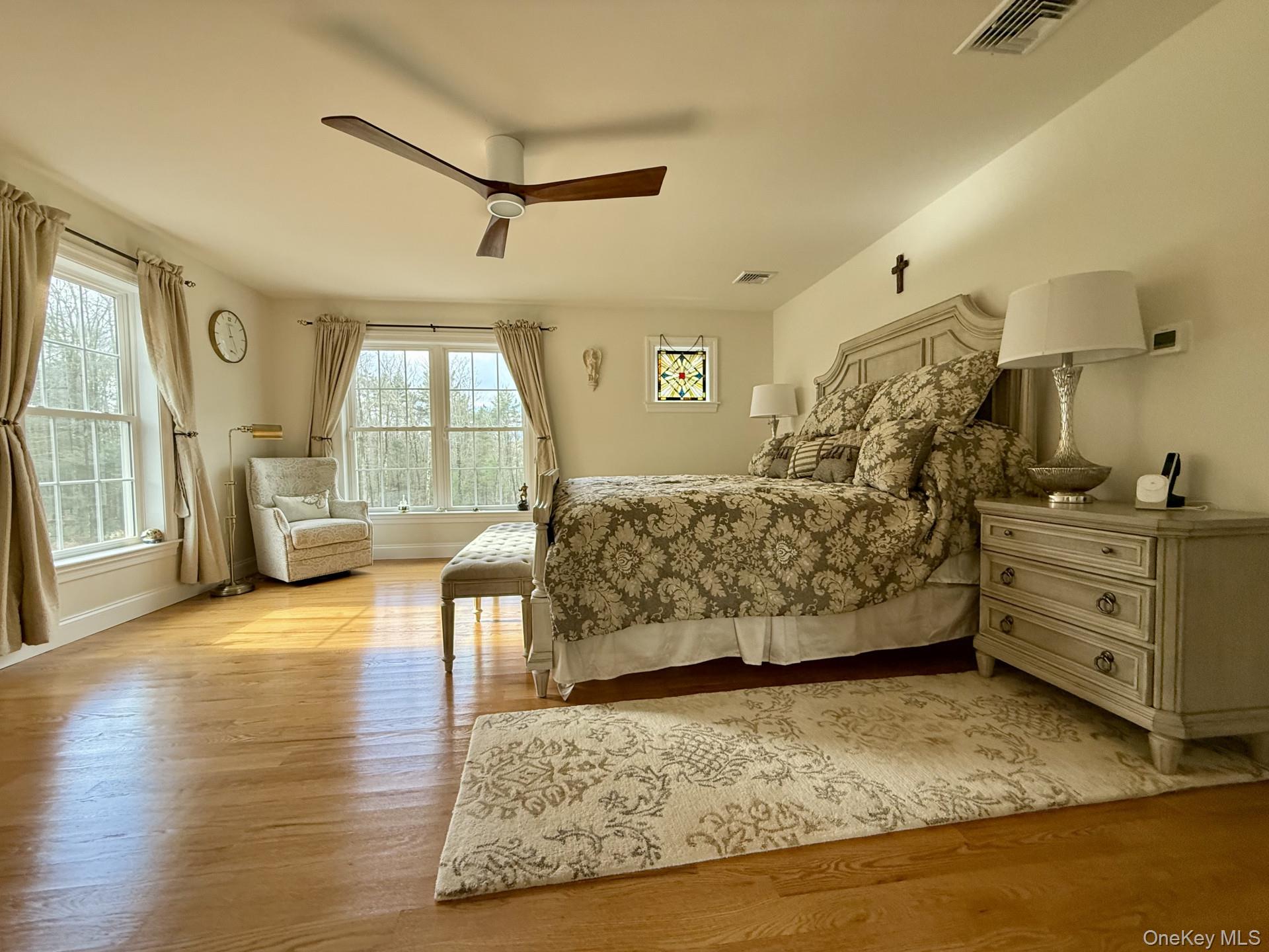 657 Sackett Lake Road Monticello, NY 12701 - Photo 15 of 36 a bedroom with furniture and a wooden floor