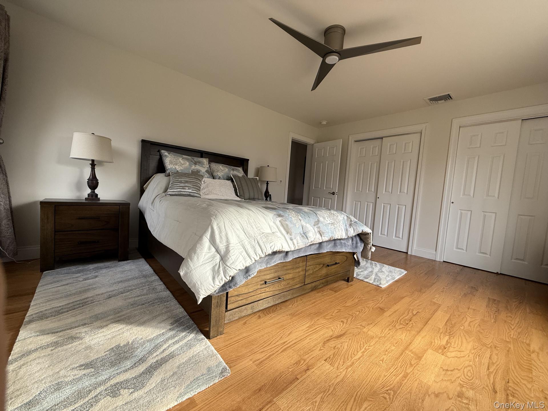 657 Sackett Lake Road Monticello, NY 12701 - Photo 19 of 36 a bedroom with a bed and a night stand