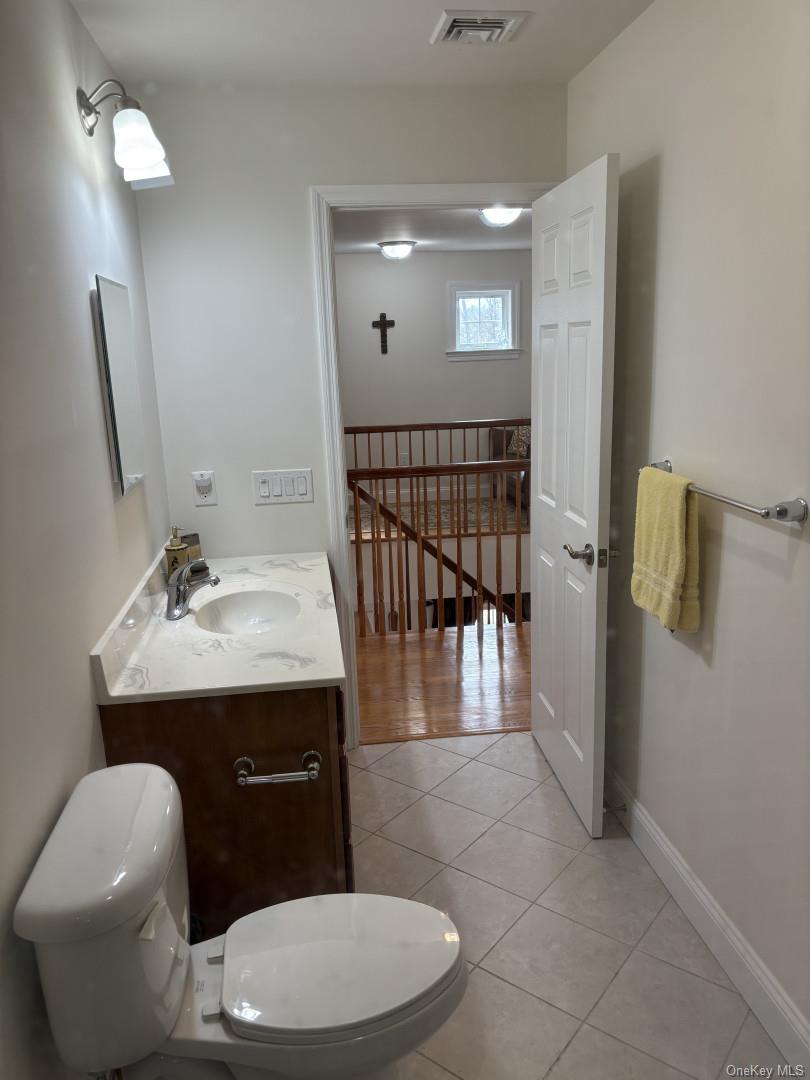 657 Sackett Lake Road Monticello, NY 12701 - Photo 22 of 36 a bathroom with a toilet sink and mirror