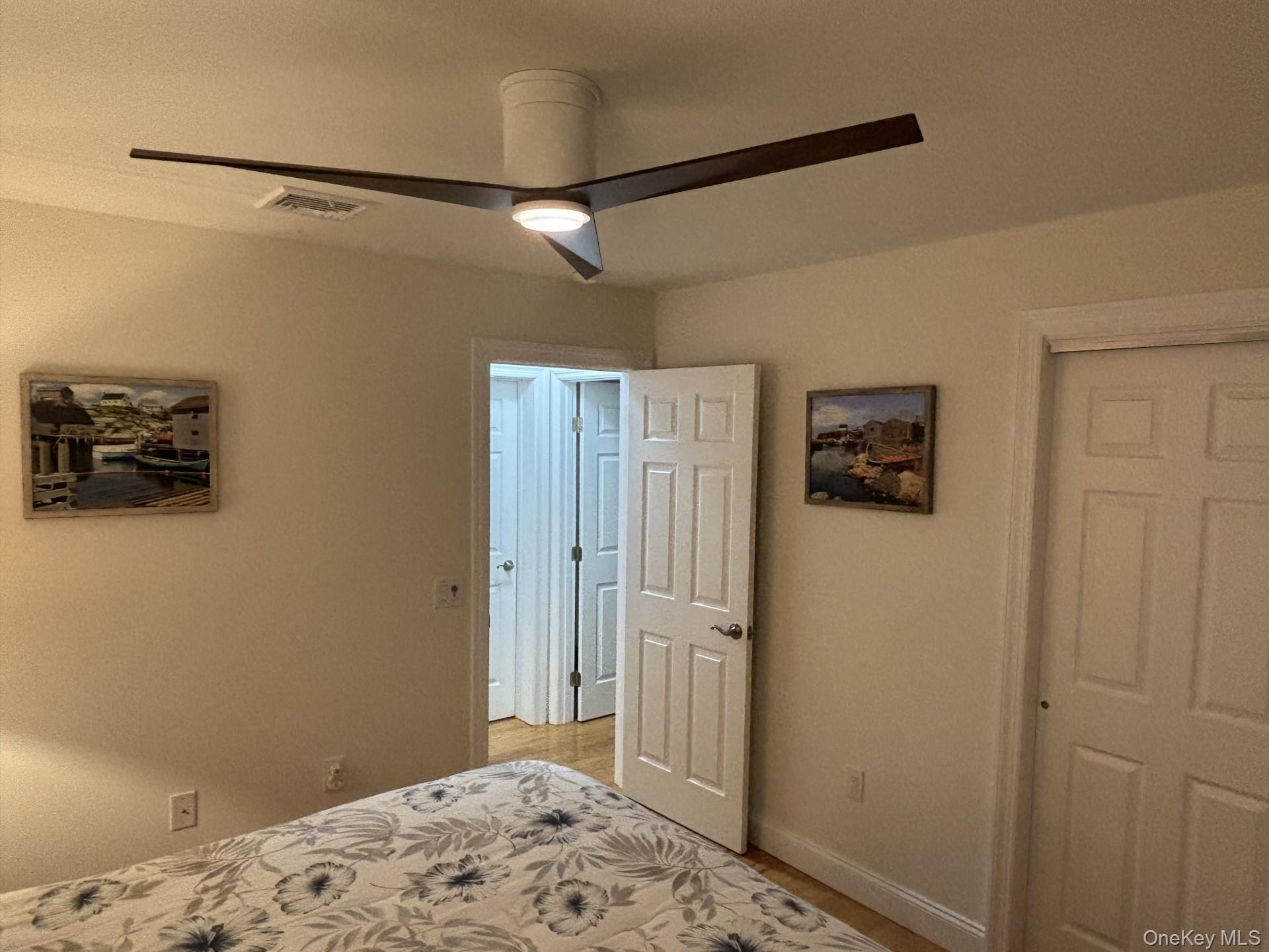 657 Sackett Lake Road Monticello, NY 12701 - Photo 24 of 36 a bedroom with a bed and a view of bathroom