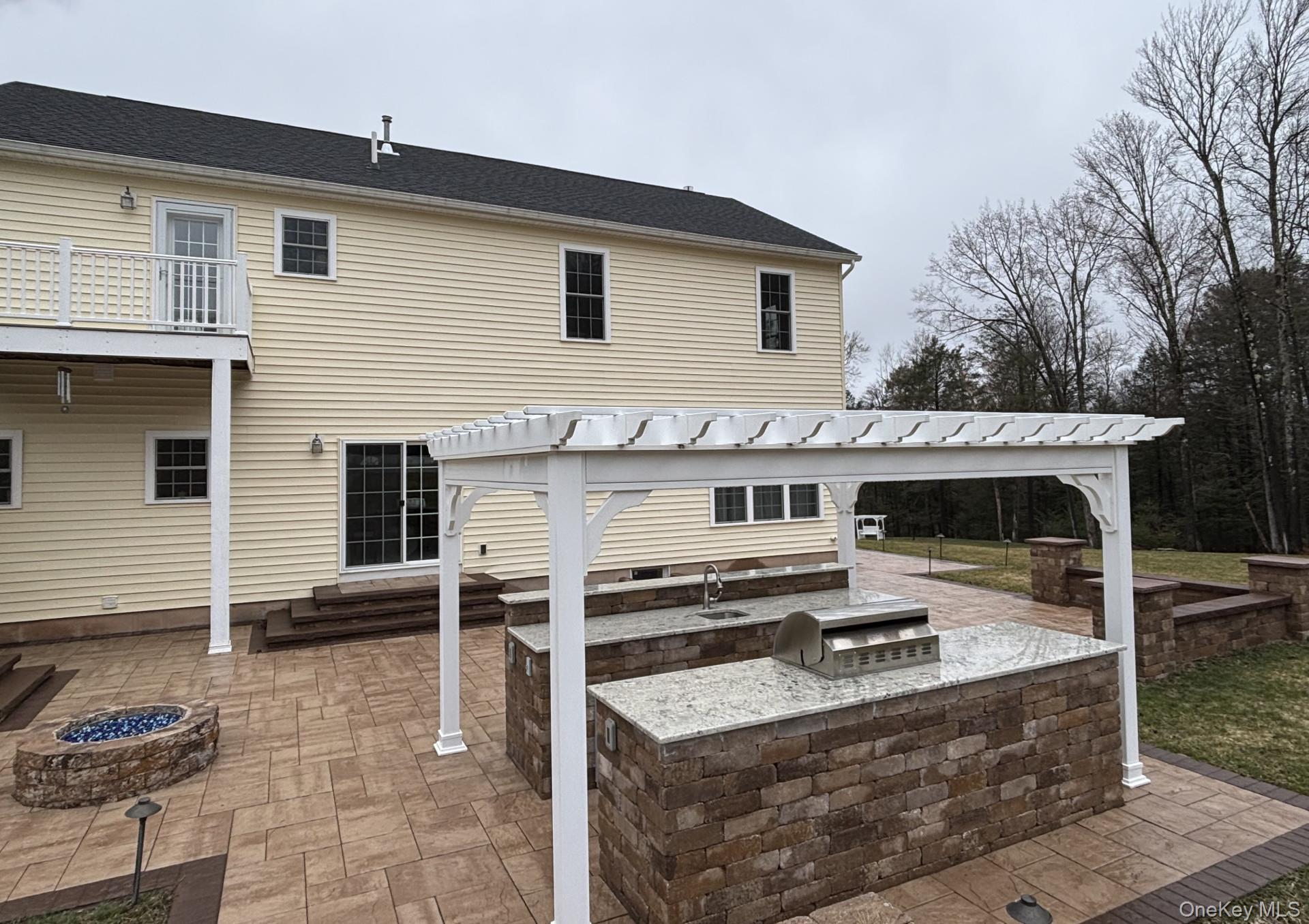 657 Sackett Lake Road Monticello, NY 12701 - Photo 33 of 36 a view of a white house with a sink and glass table