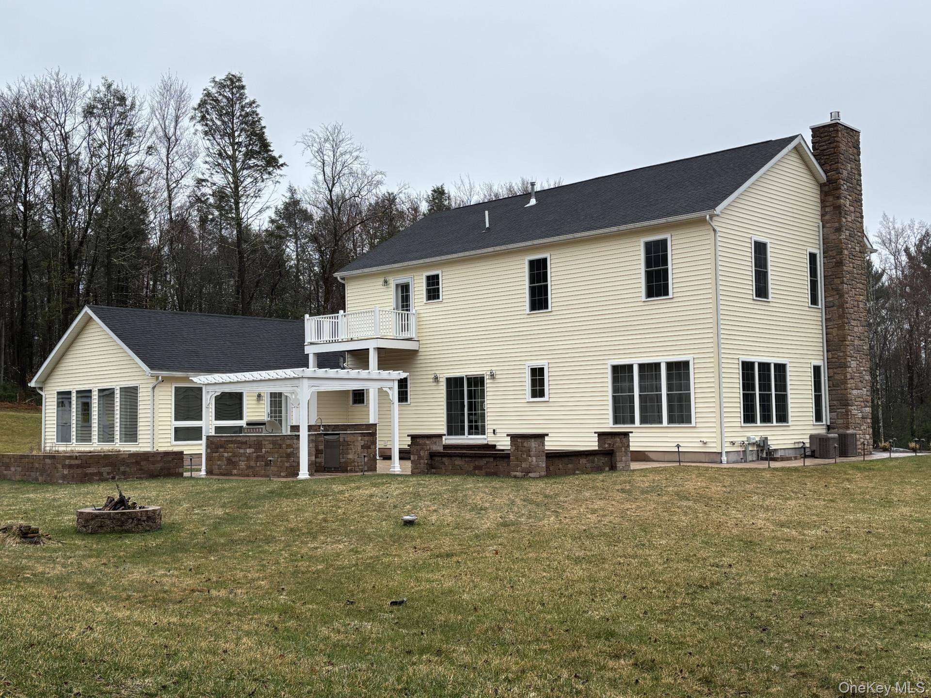 657 Sackett Lake Road Monticello, NY 12701 - Photo 34 of 36 a white house that has a tree in front of it