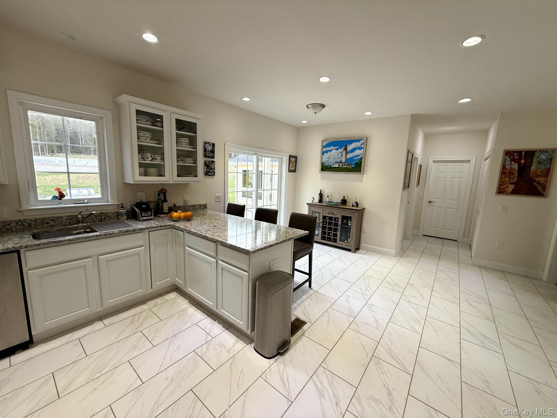 657 Sackett Lake Road Monticello, NY 12701 - Photo 4 of 36 a large white kitchen with cabinets