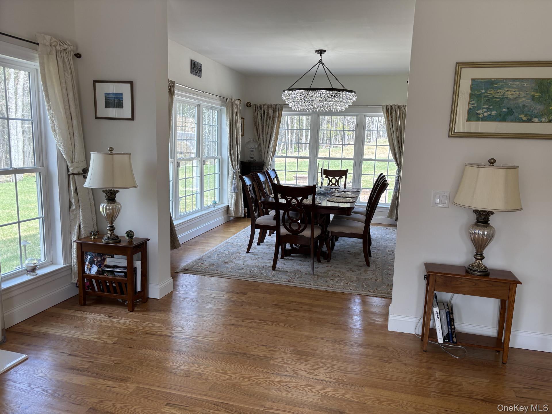 657 Sackett Lake Road Monticello, NY 12701 - Photo 7 of 36 a view of a dining room with furniture window and wooden floor