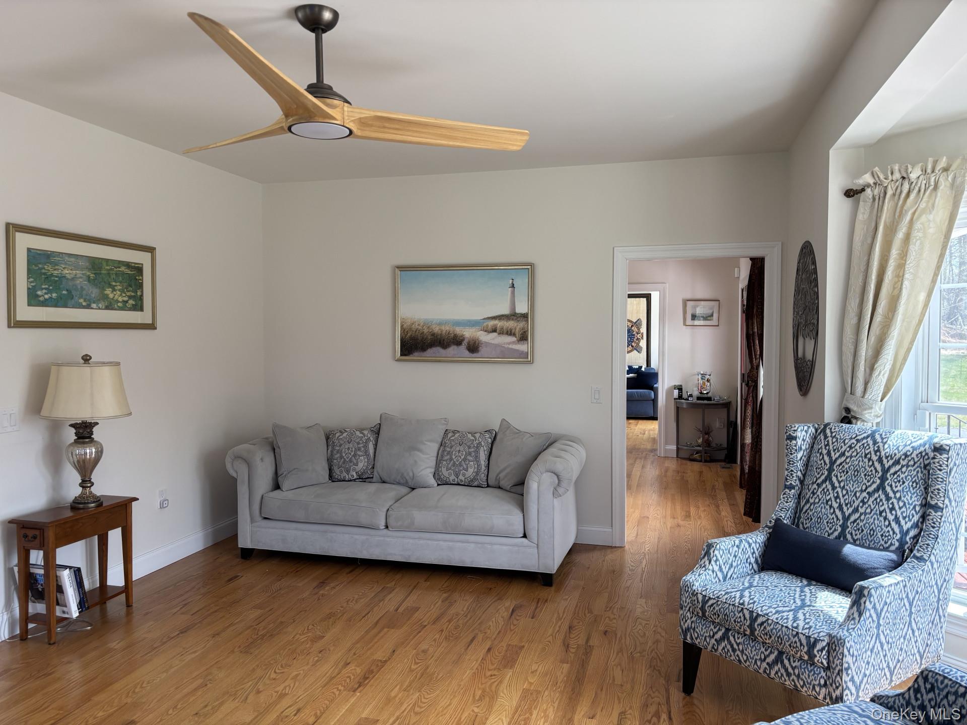 657 Sackett Lake Road Monticello, NY 12701 - Photo 9 of 36 a living room with furniture and a wooden floor