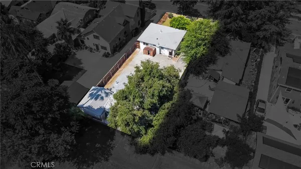 an aerial view of a house with a yard and garden