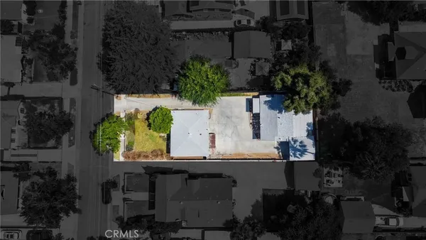 an aerial view of a house with a yard