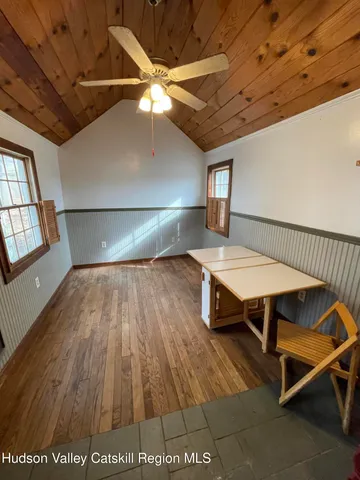 a room with wooden floor and furniture