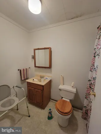 a bathroom with a granite countertop toilet and a sink