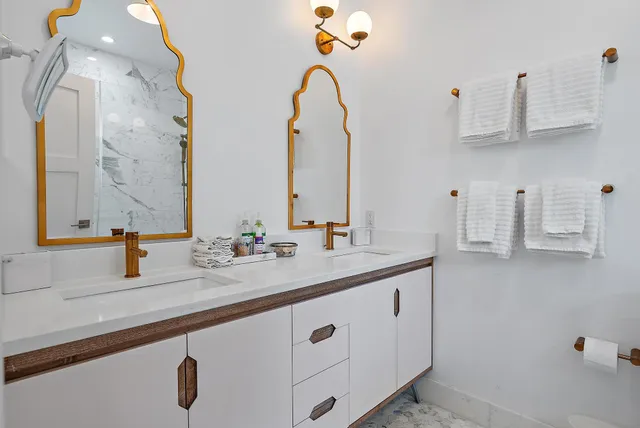 a bathroom with a double vanity sink and a mirror