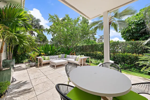 a view of a backyard with sitting area