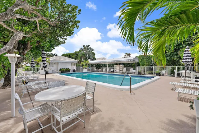 a view of a backyard with swimming pool