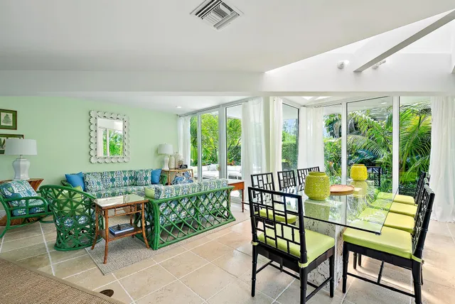 a living room with furniture and a floor to ceiling window