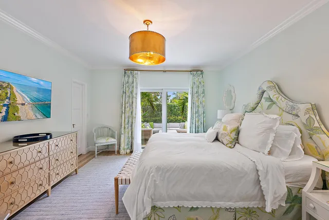 a bedroom with a bed and a wooden floor