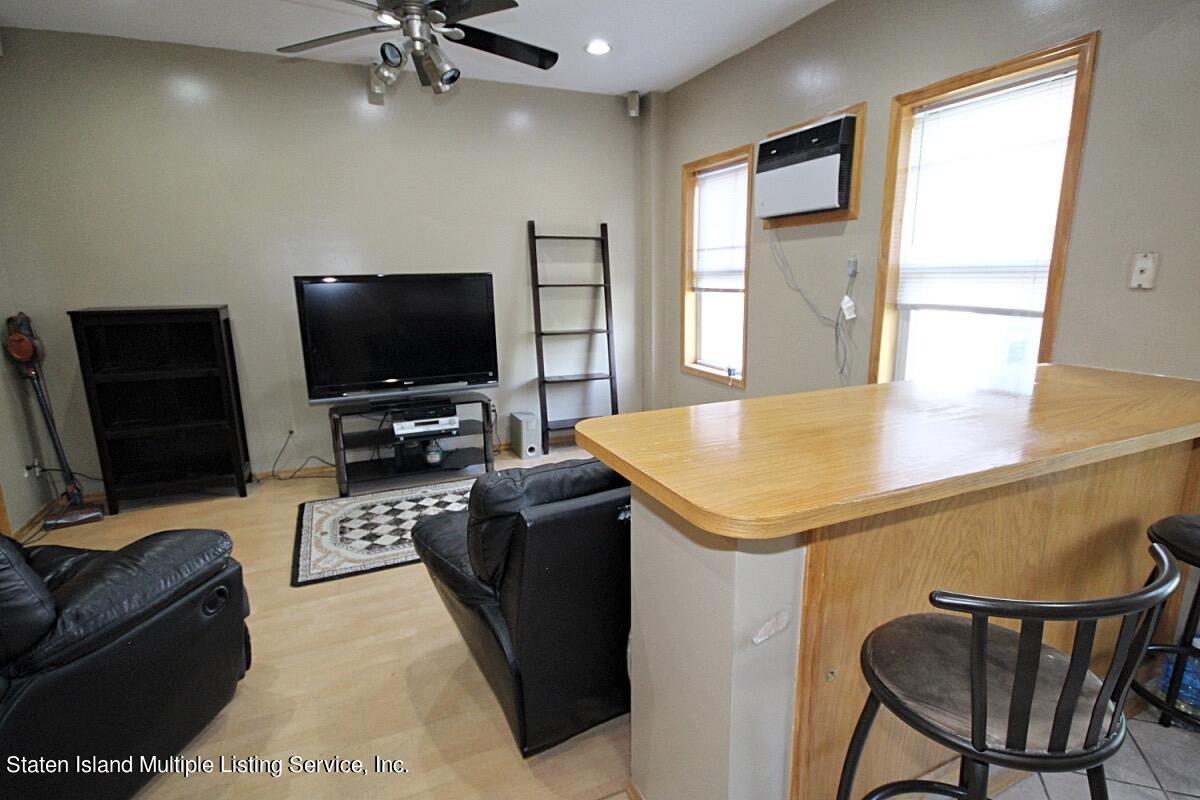 985 Lorimer Street Brooklyn, NY 11222 - Photo 14 of 23 a living room with furniture and a flat screen tv