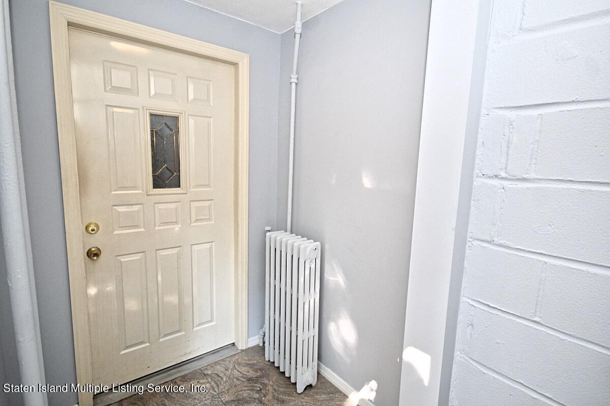 985 Lorimer Street Brooklyn, NY 11222 - Photo 3 of 23 a view of a door and a bathroom with mirror